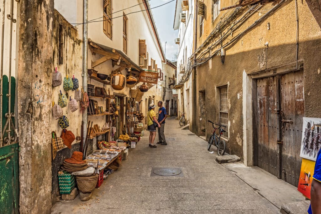 Tourists on a typical narrow street in Stone Town, Zanzibar